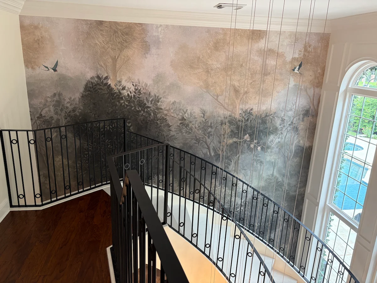 Scenic landscape mural surrounding an open staircase